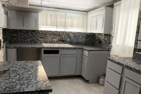 Gran Pearl kitchen countertop with white cabinets